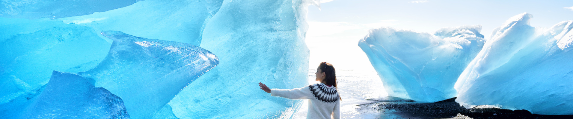 femme touchant un iceberg en islande